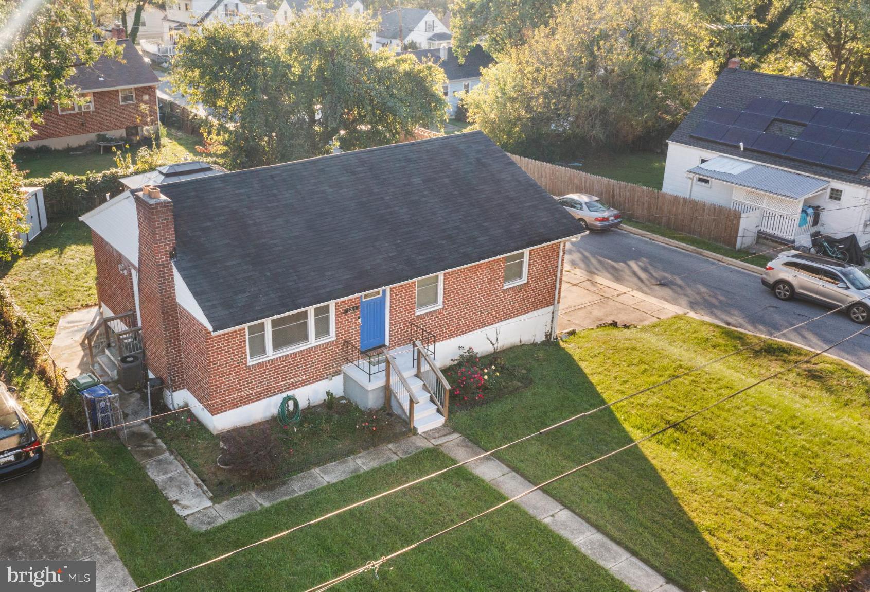 5219 West North Avenue Baltimore, MD 21207 - Photo 1 of 34 Charming brick home with vibrant blue door.