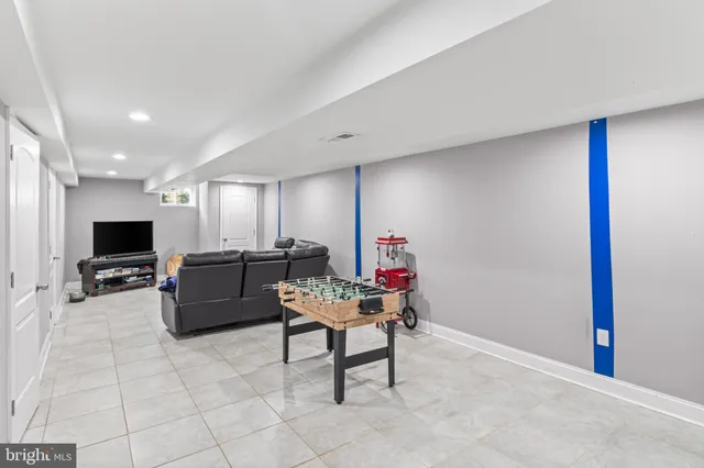 a room with furniture a flat screen tv and a window