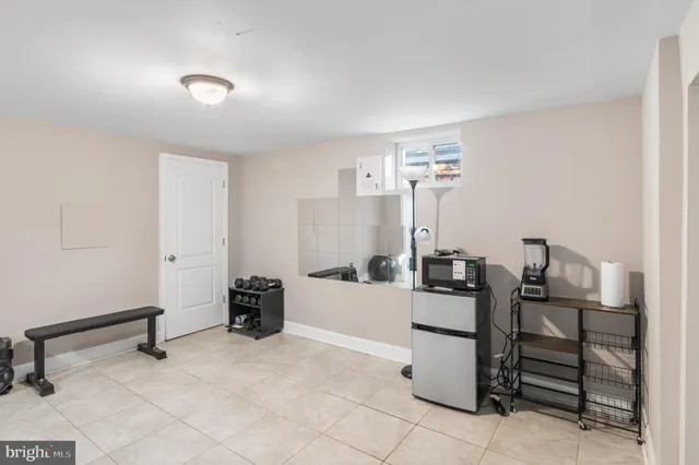 a view of kitchen with furniture and refrigerator
