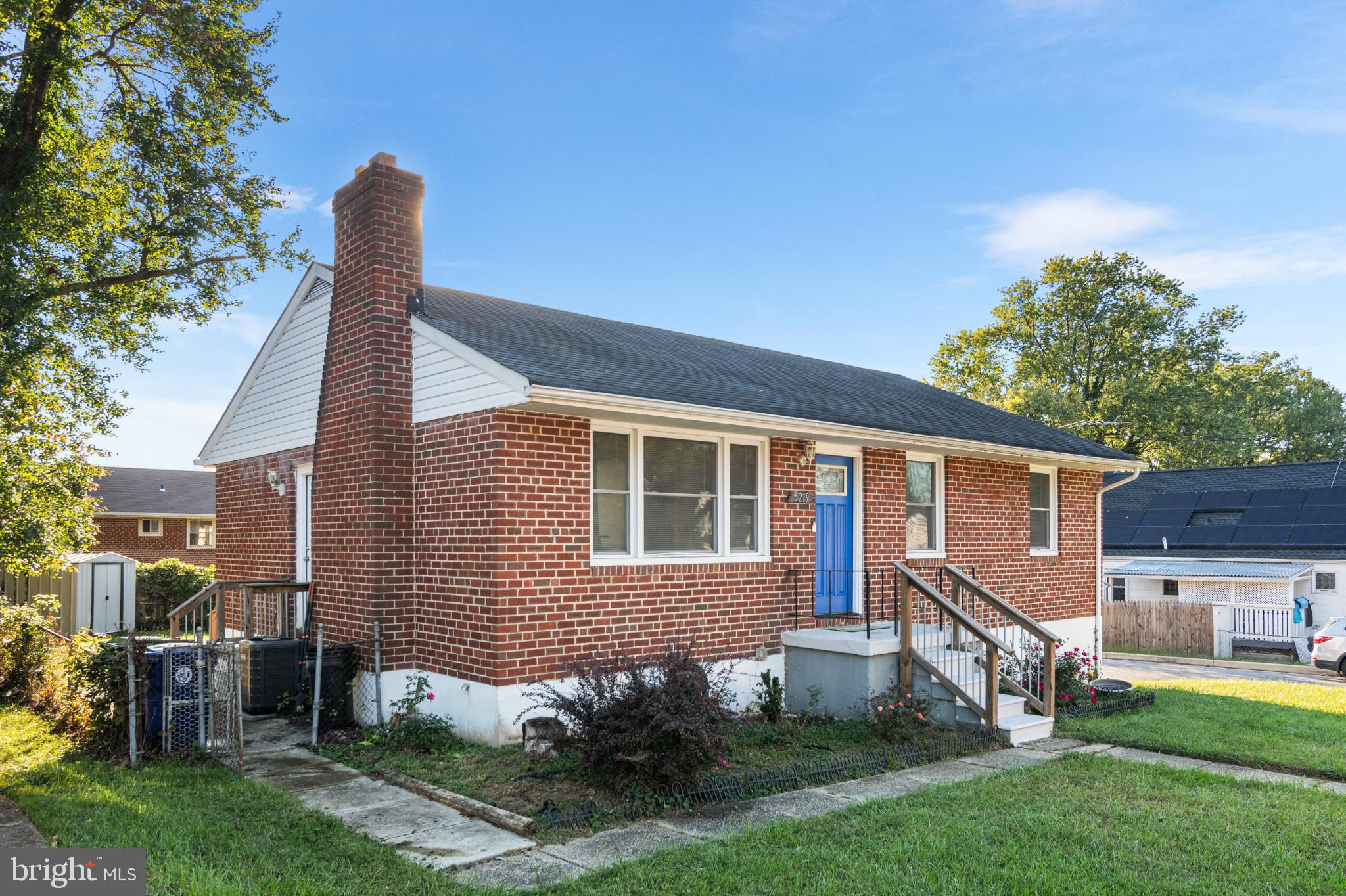 5219 West North Avenue Baltimore, MD 21207 - Photo 26 of 34 Charming brick home with vibrant blue door.