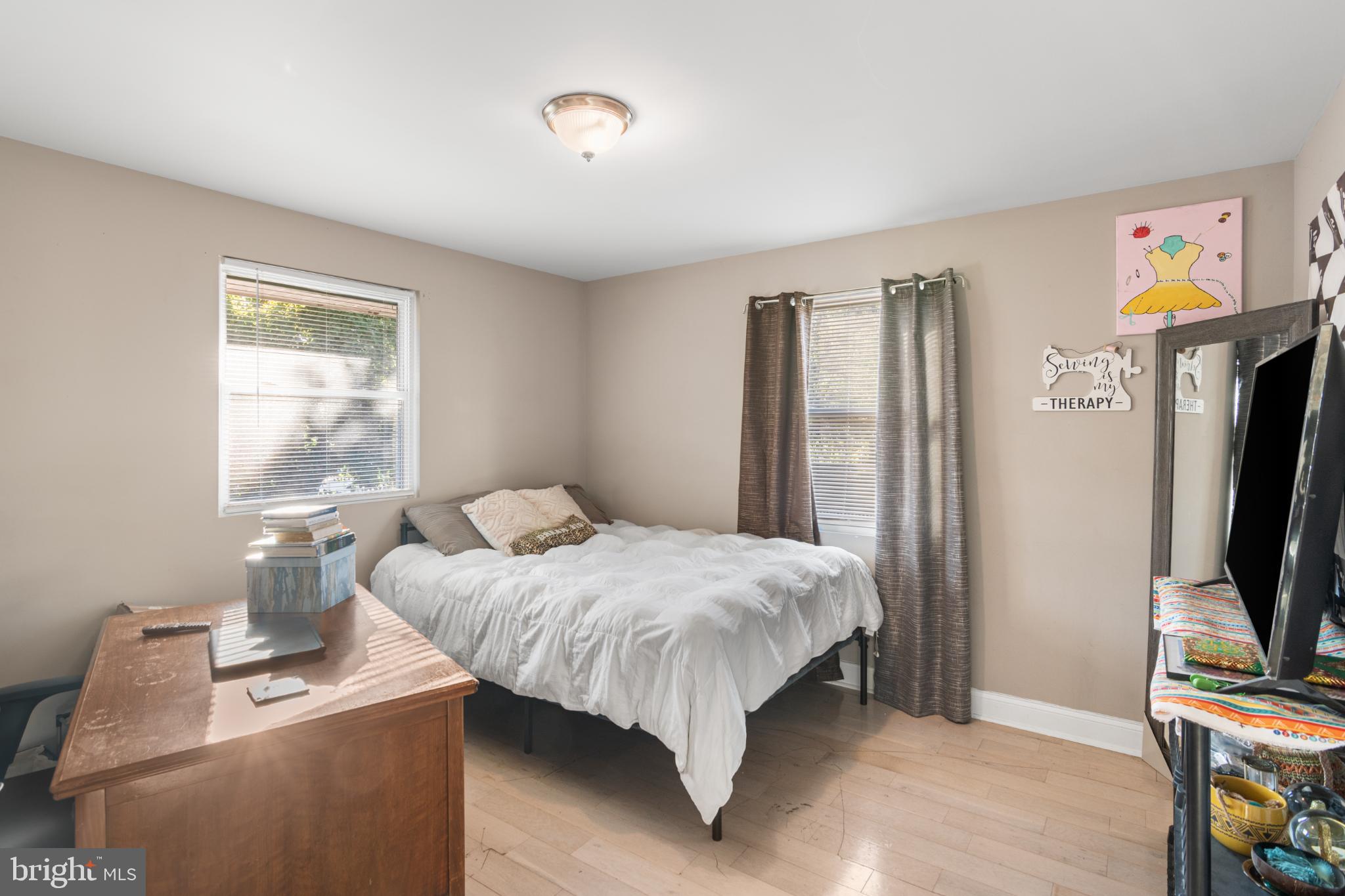 5219 West North Avenue Baltimore, MD 21207 - Photo 10 of 34 Cozy bedroom with natural light and charm.