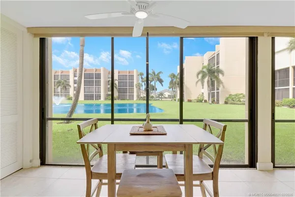 a dining room with furniture and window