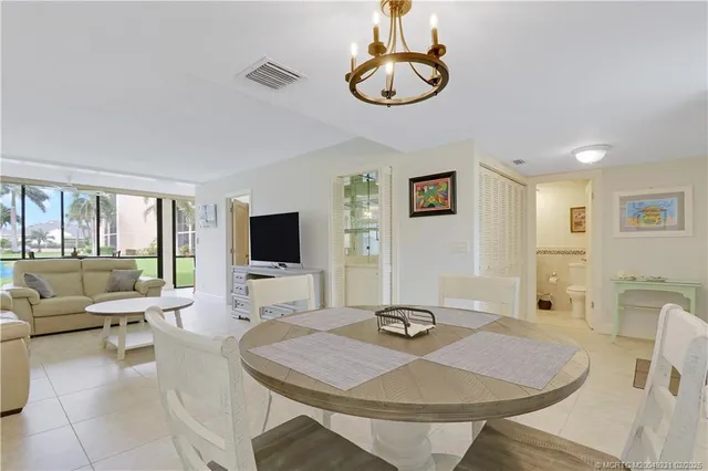 a living room with furniture a flat screen tv and a table