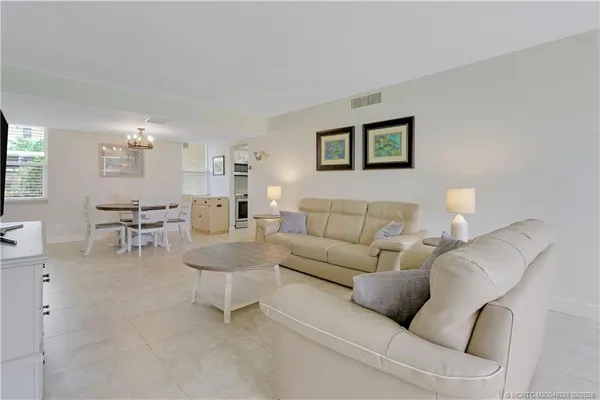 a living room with furniture and a lamp