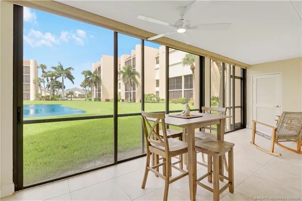 a view of a room with a large window and dining table