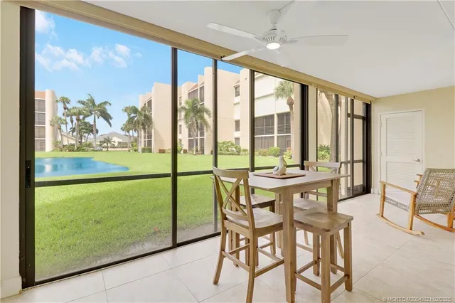 a view of a room with a large window and dining table