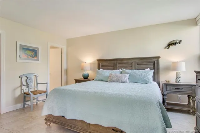 a bedroom with a bed a table and chair