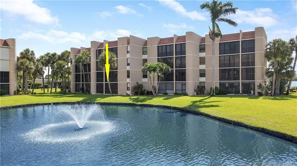 a view of a swimming pool with a yard and plants