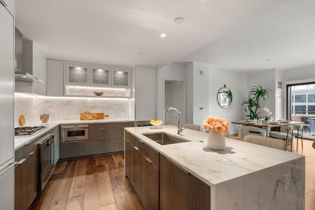 a kitchen that has a sink and a stove in it