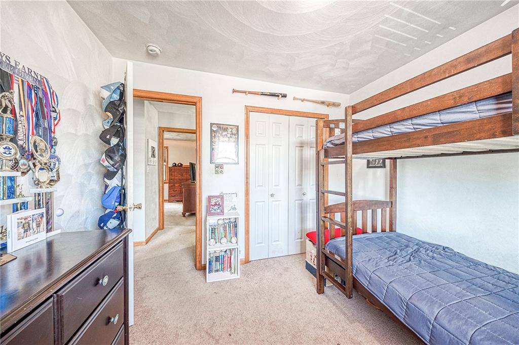 124 Rustic Ridge Drive Pittsburgh, PA 15239 - Photo 12 of 30 a bedroom with a bed and a chandelier