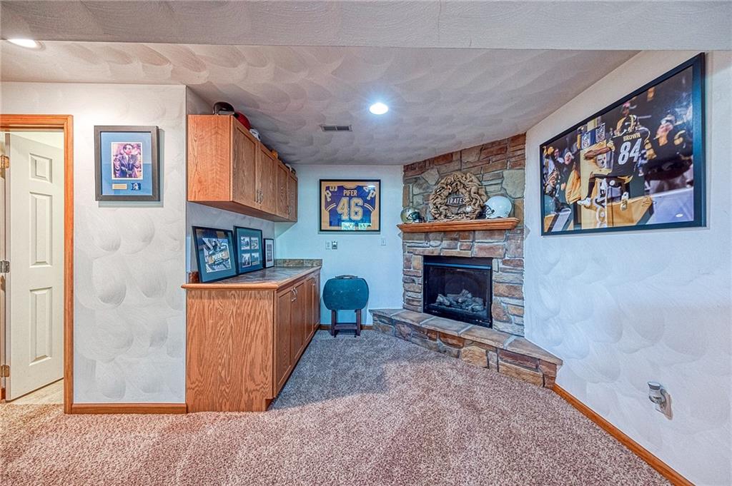124 Rustic Ridge Drive Pittsburgh, PA 15239 - Photo 19 of 30 a living room with furniture a fireplace and a wall painting