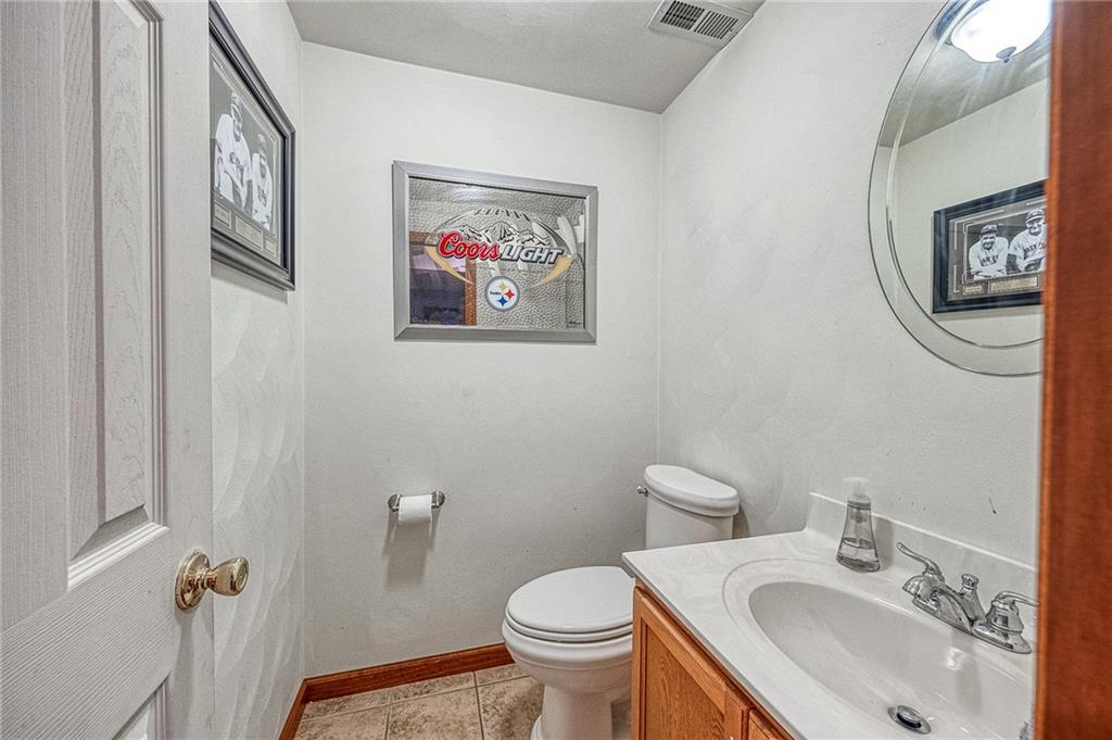124 Rustic Ridge Drive Pittsburgh, PA 15239 - Photo 20 of 30 a bathroom with a toilet a sink and mirror