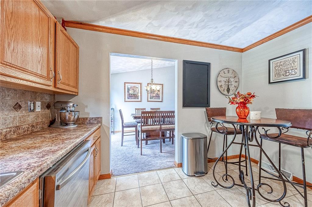 124 Rustic Ridge Drive Pittsburgh, PA 15239 - Photo 6 of 30 a view of a kitchen with dining table and chairs
