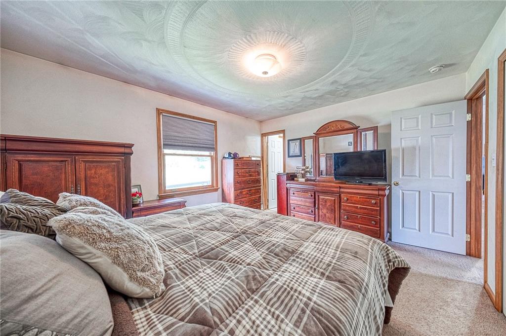 124 Rustic Ridge Drive Pittsburgh, PA 15239 - Photo 9 of 30 a bedroom with a bed and flat screen tv