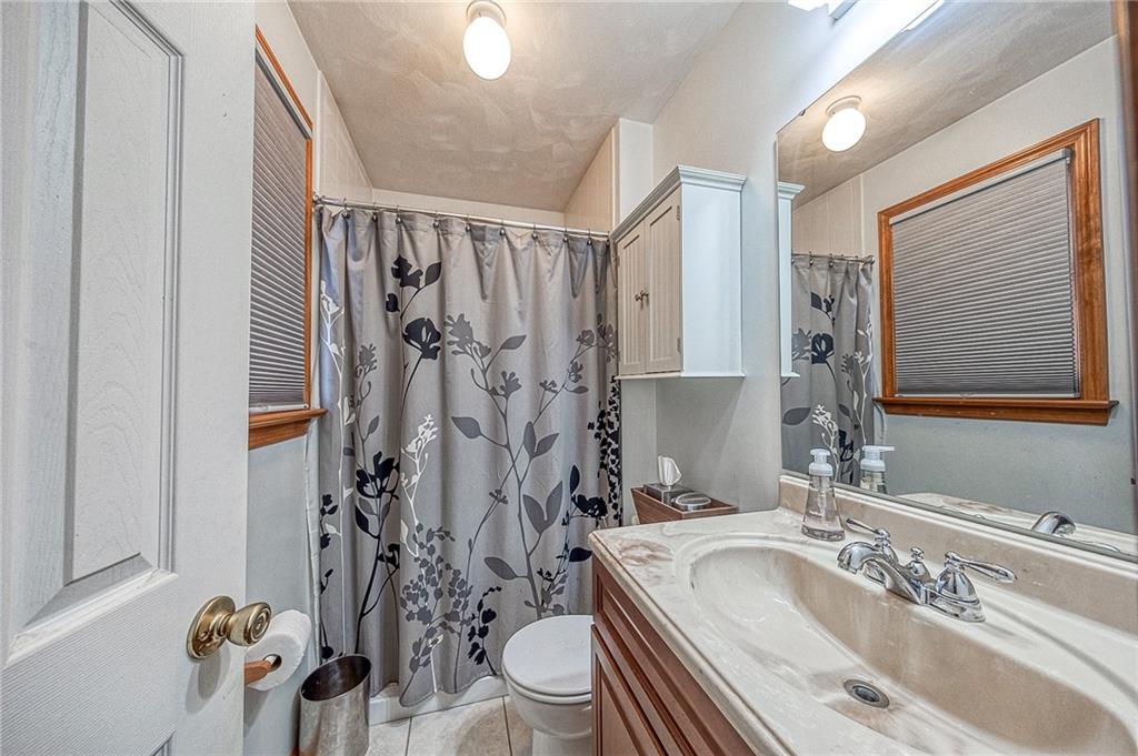 124 Rustic Ridge Drive Pittsburgh, PA 15239 - Photo 10 of 30 a bathroom with a granite countertop sink and a bathtub