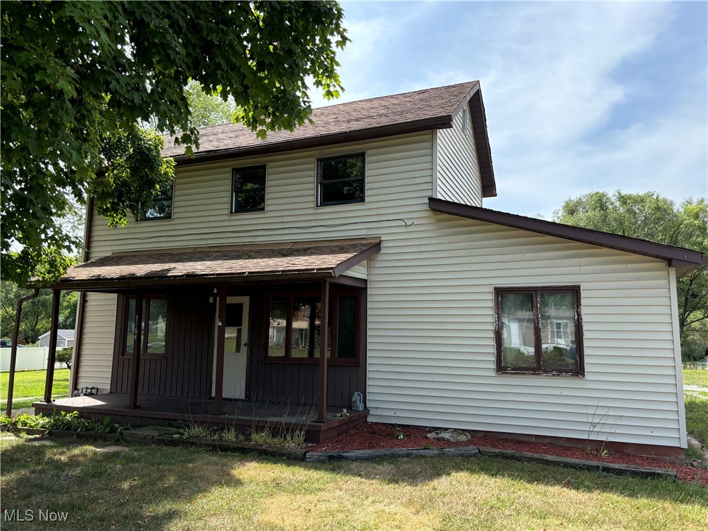 5164 Rutledge Street Southeast Dennison, OH 44621 - Photo 1 of 14 Rear view of property featuring a porch and a yard