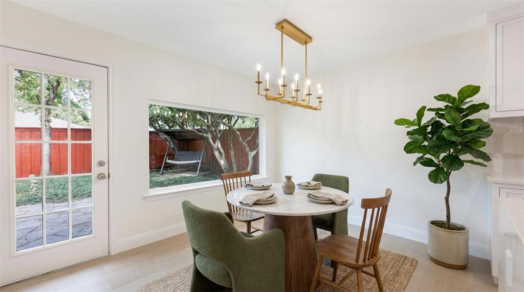 2707 Quail Ridge Drive Carrollton, TX 75006 - Photo 13 of 32 a dining room with furniture potted plants and wooden floor