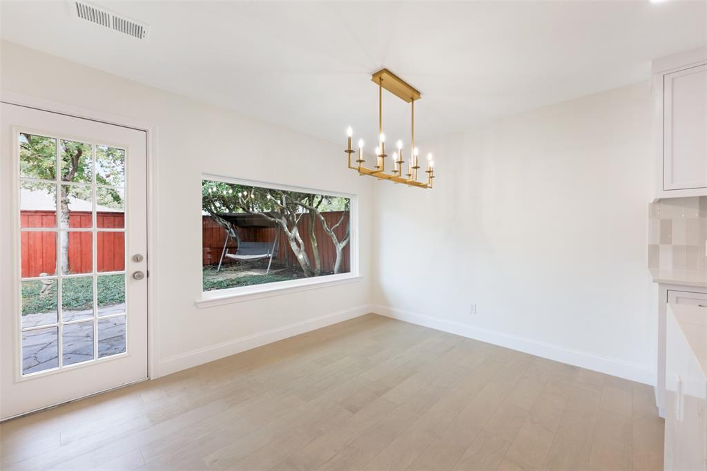 2707 Quail Ridge Drive Carrollton, TX 75006 - Photo 14 of 32 a view of wooden floor chandelier and window in a room