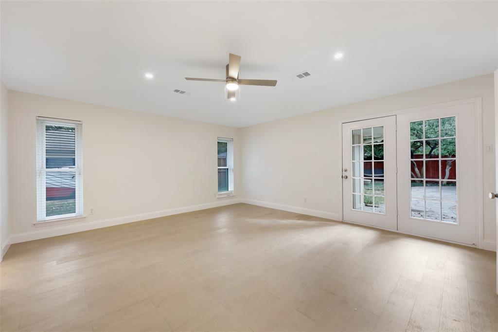 2707 Quail Ridge Drive Carrollton, TX 75006 - Photo 21 of 32 a view of an empty room with a window and wooden floor