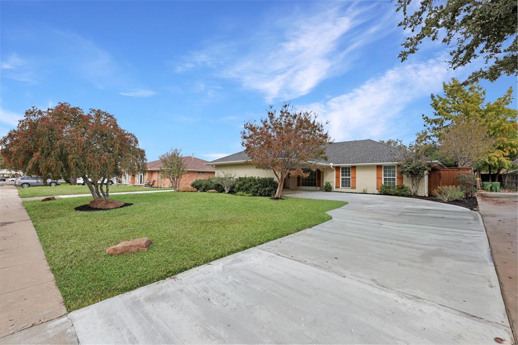 2707 Quail Ridge Drive Carrollton, TX 75006 - Photo 29 of 32 front view of a house with a yard