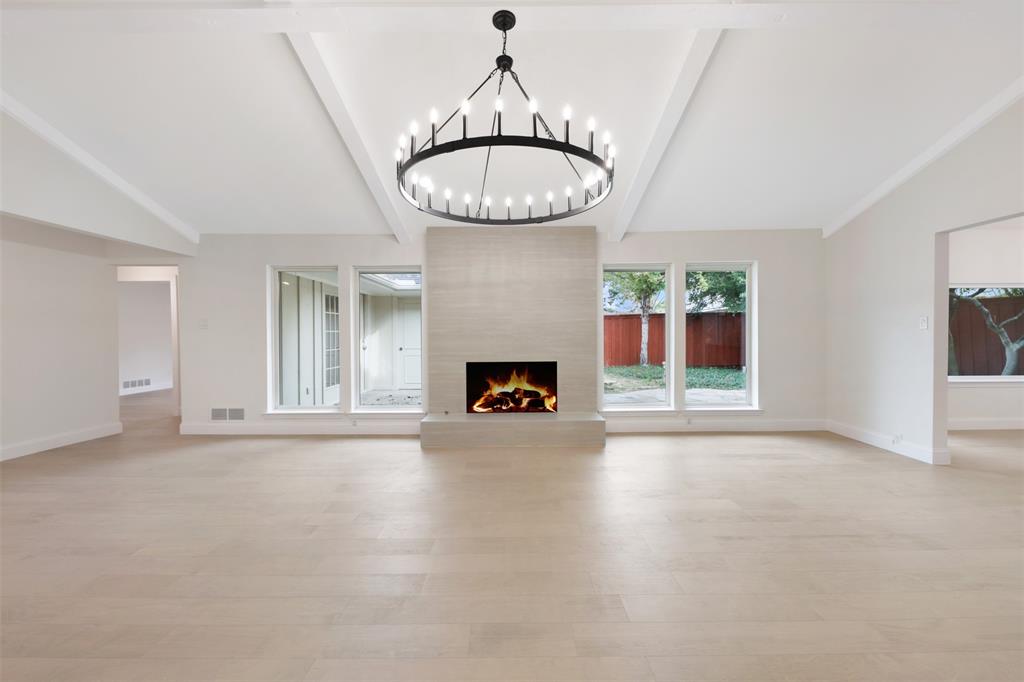 2707 Quail Ridge Drive Carrollton, TX 75006 - Photo 3 of 32 a view of an empty room with a fireplace and window