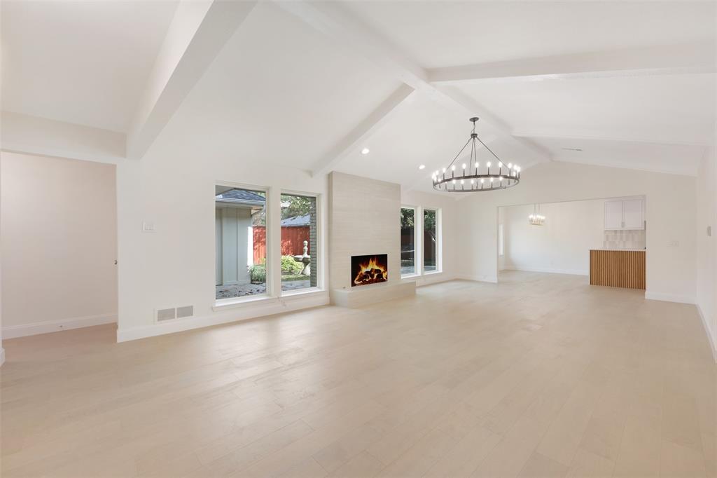 2707 Quail Ridge Drive Carrollton, TX 75006 - Photo 4 of 32 an empty room with fireplace and windows
