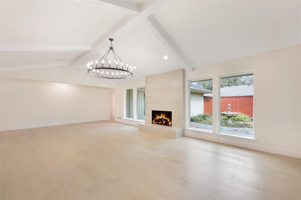 2707 Quail Ridge Drive Carrollton, TX 75006 - Photo 5 of 32 an empty room with windows and fireplace