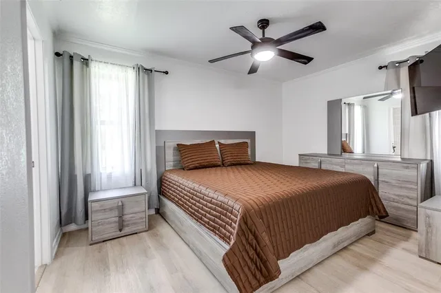 a bedroom with a large bed and a large window