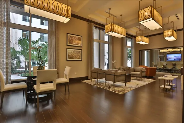 a living room with fireplace furniture and a large window
