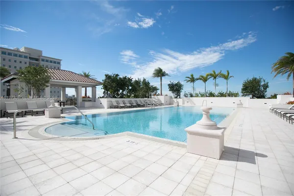a view of a patio with swimming pool and furniture