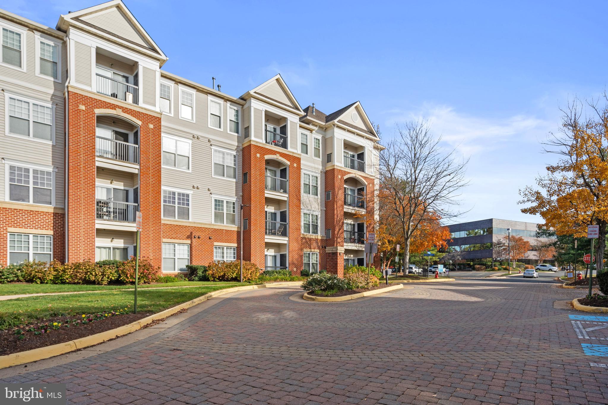 3851 Aristotle Court, Unit 1402 Fairfax, VA 22030 - Photo 1 of 31 a city street lined with buildings and trees