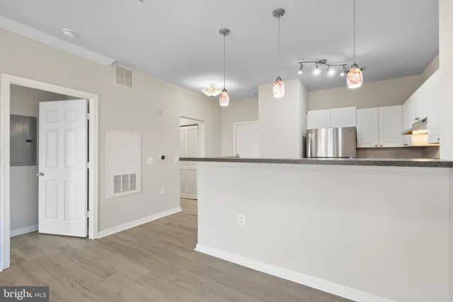 a view of a kitchen with a sink and chandelier
