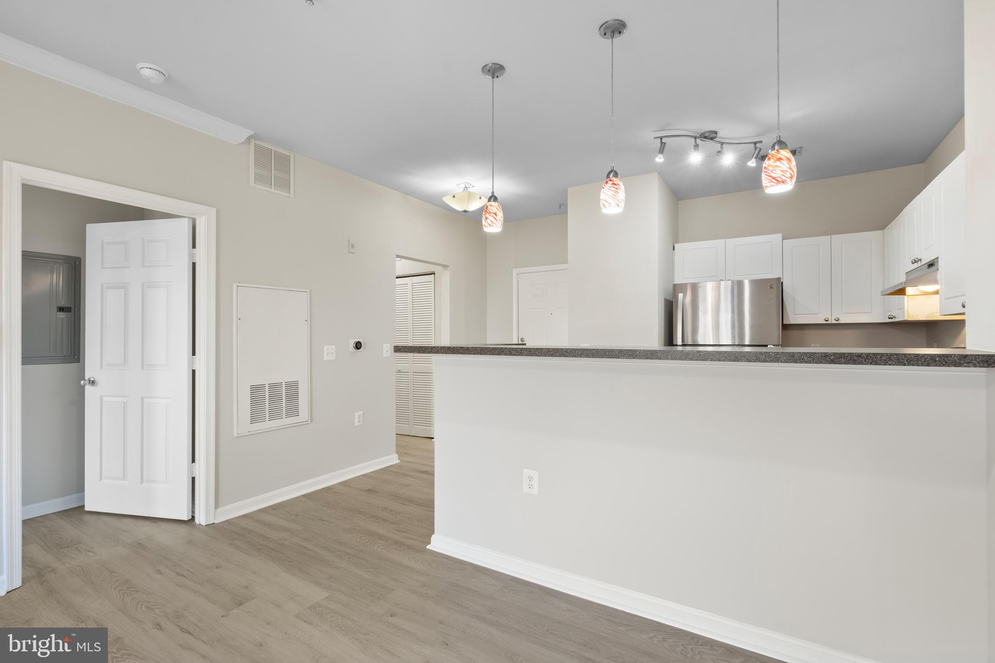 3851 Aristotle Court, Unit 1402 Fairfax, VA 22030 - Photo 13 of 31 a view of a kitchen with a sink and chandelier