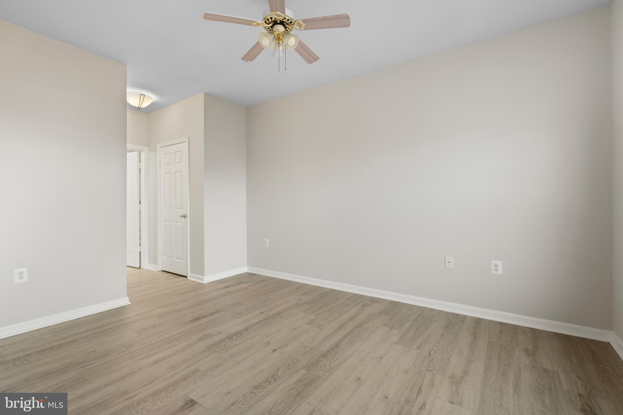 3851 Aristotle Court, Unit 1402 Fairfax, VA 22030 - Photo 15 of 31 a view of an empty room with wooden floor