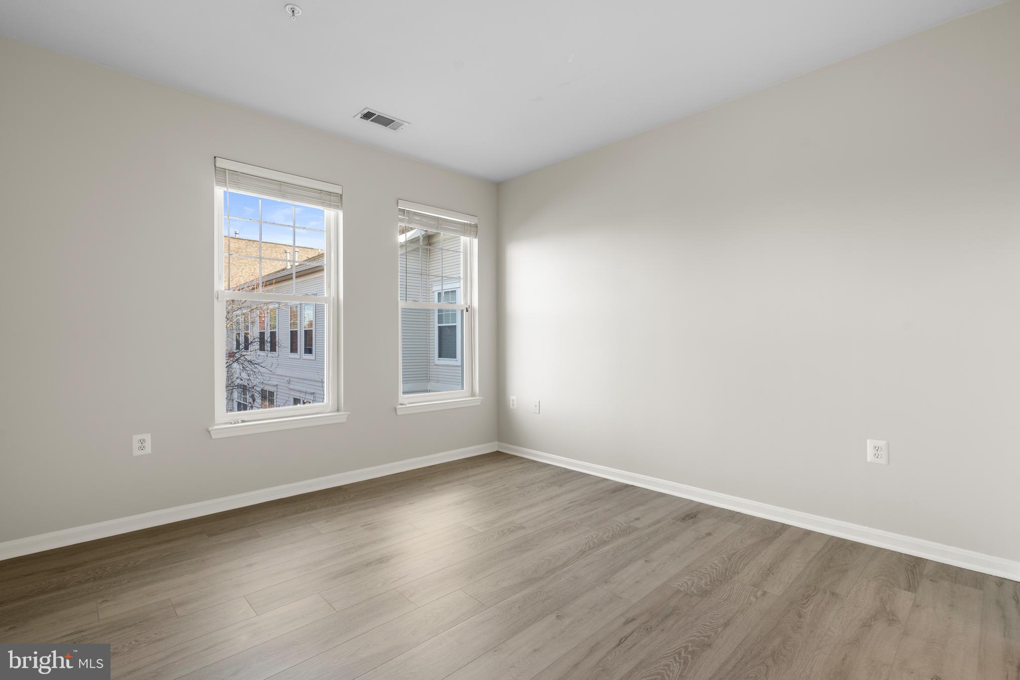 3851 Aristotle Court, Unit 1402 Fairfax, VA 22030 - Photo 22 of 31 a view of an empty room with wooden floor and window
