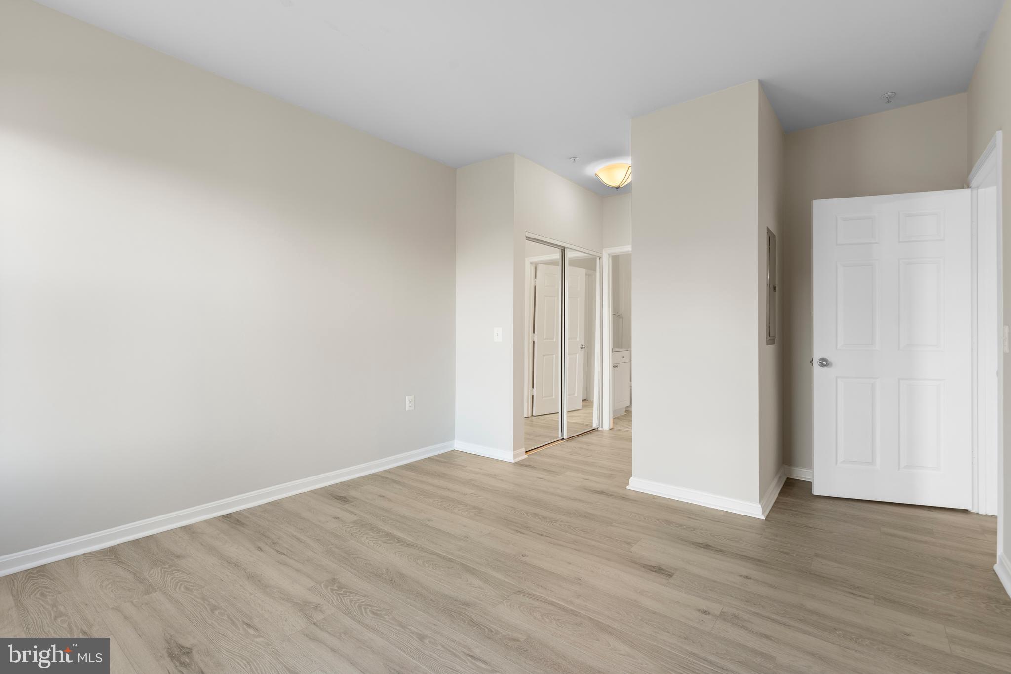 3851 Aristotle Court, Unit 1402 Fairfax, VA 22030 - Photo 23 of 31 a view of an empty room with wooden floor