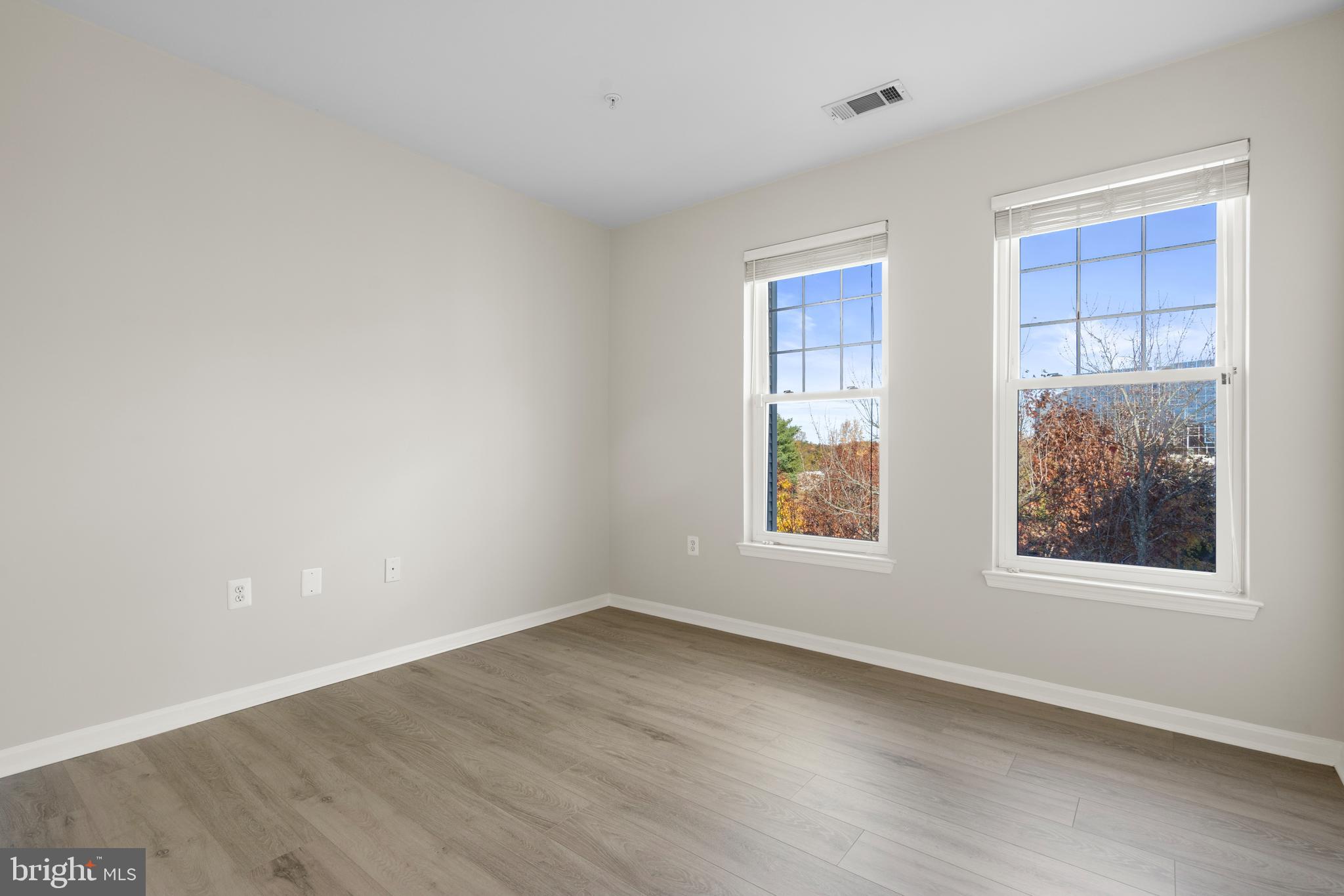 3851 Aristotle Court, Unit 1402 Fairfax, VA 22030 - Photo 24 of 31 an empty room with wooden floor and windows