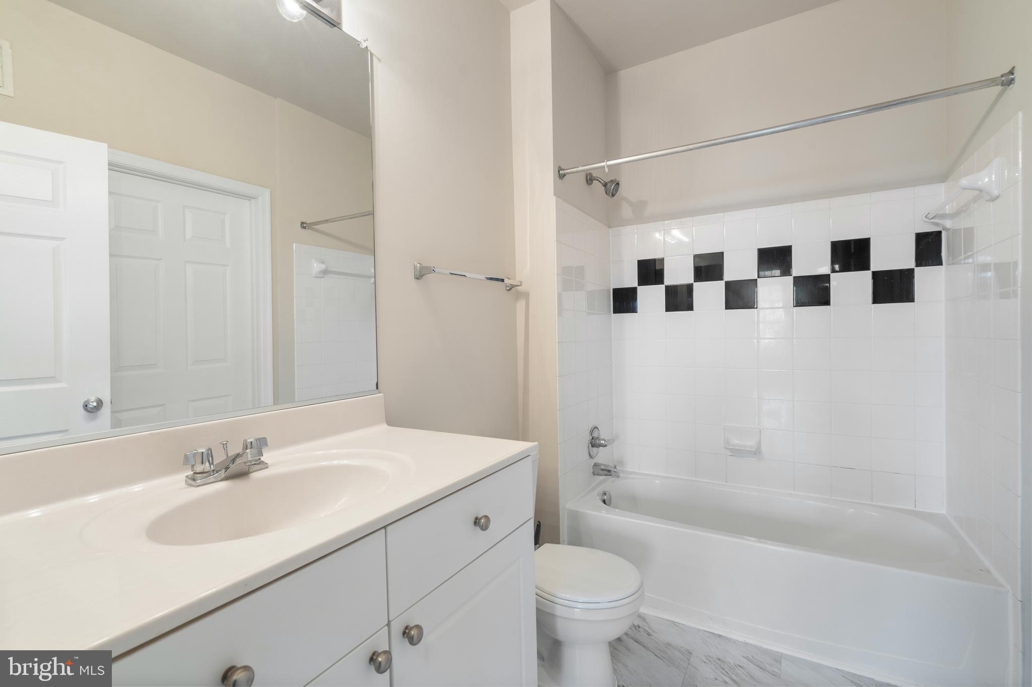 3851 Aristotle Court, Unit 1402 Fairfax, VA 22030 - Photo 25 of 31 a bathroom with a sink a toilet and shower