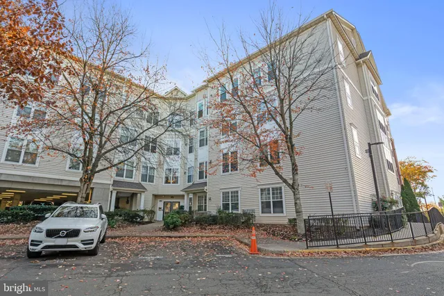 a car parked in front of a white house