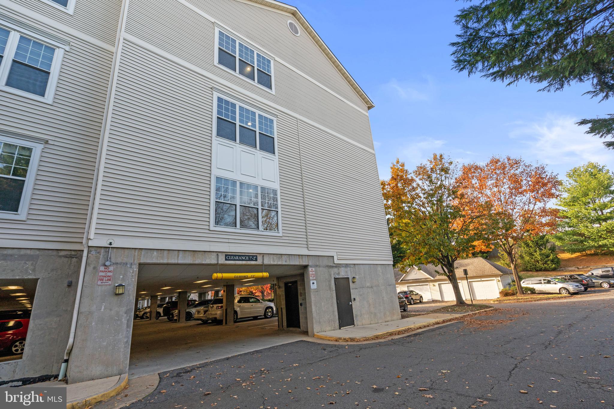3851 Aristotle Court, Unit 1402 Fairfax, VA 22030 - Photo 29 of 31 a front view of a building with garden and parking