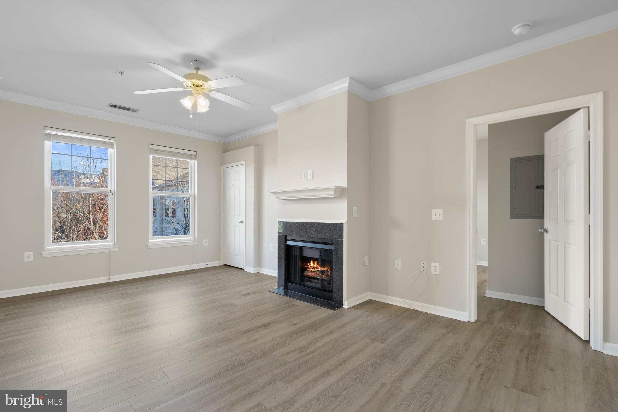 3851 Aristotle Court, Unit 1402 Fairfax, VA 22030 - Photo 5 of 31 a view of an empty room with wooden floor fireplace and a window