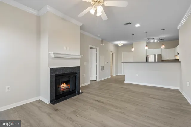 a view of an empty room with a fireplace and a window