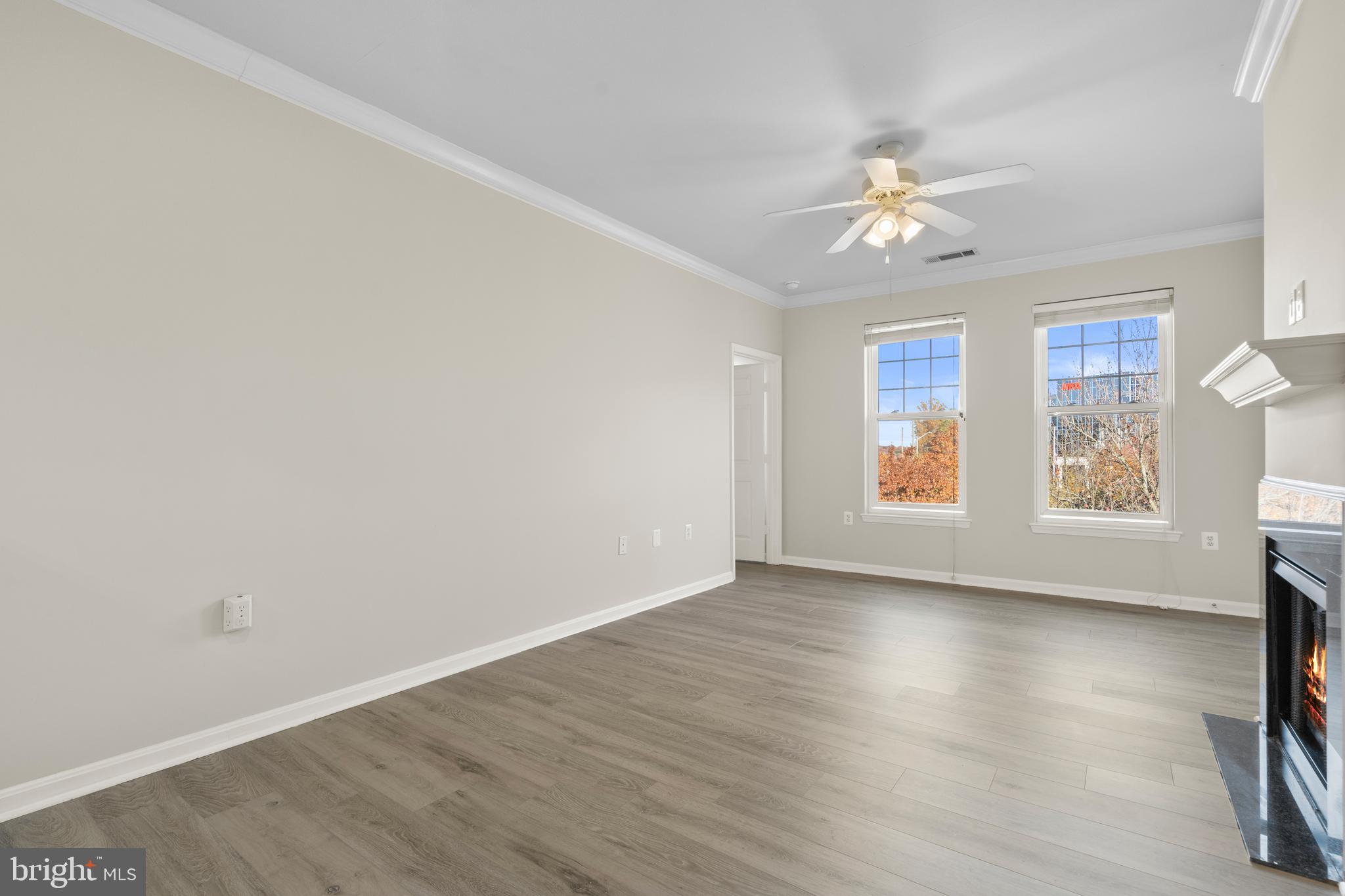 3851 Aristotle Court, Unit 1402 Fairfax, VA 22030 - Photo 7 of 31 wooden floor in an empty room with a window