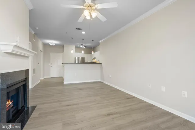 a view of a kitchen with a sink a fireplace and wooden floor