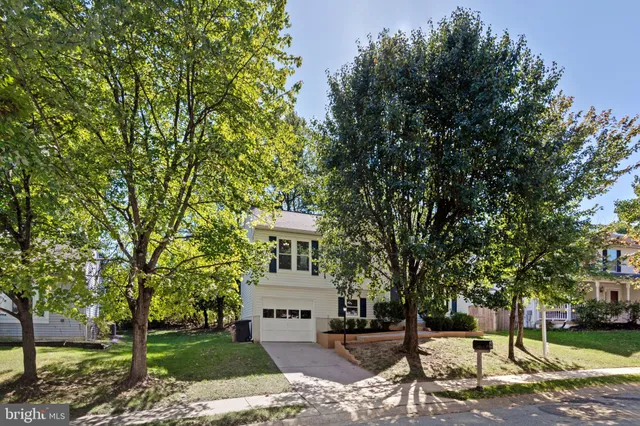 a view of a white house with a sink and yard