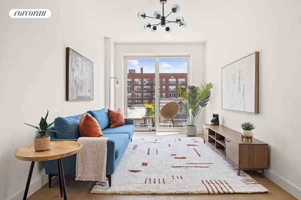 a living room with furniture and a chandelier