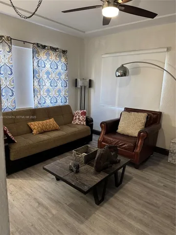 a living room with furniture and wooden floor