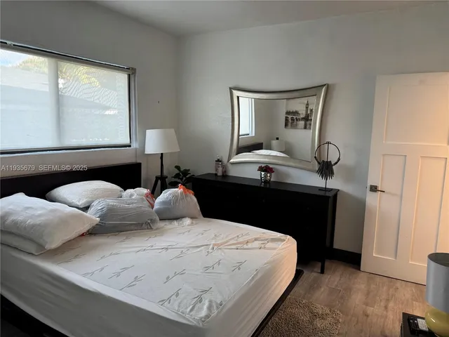 a bedroom with bed and window