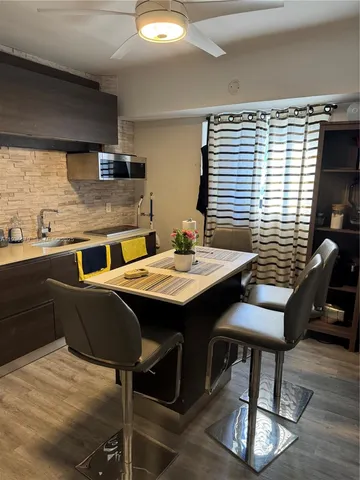 a dining room with furniture and wooden floor