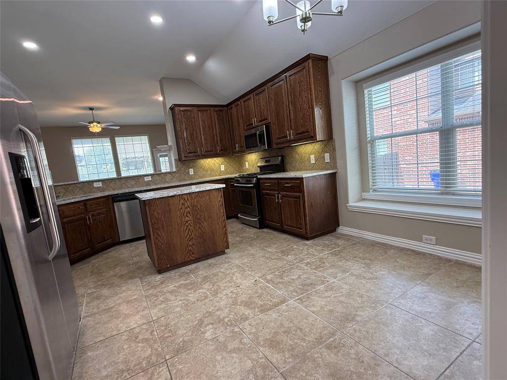 108 Cole Street Forney, TX 75126 - Photo 12 of 39 a kitchen with stainless steel appliances granite countertop a stove sink and cabinets